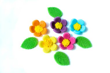 Bright sweet sugar flowers isolated on white background. Confectionery. Sweets. Background with colorful flowers with copyspace.