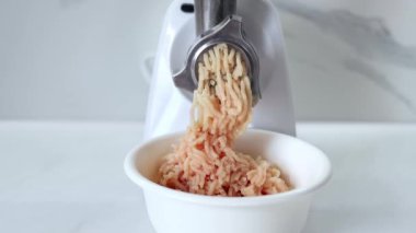 Cooking minced meat in an electric meat grinder from. The process of grinding meat in an electric meat grinder close-up. Kitchen appliances. Slow-motion.