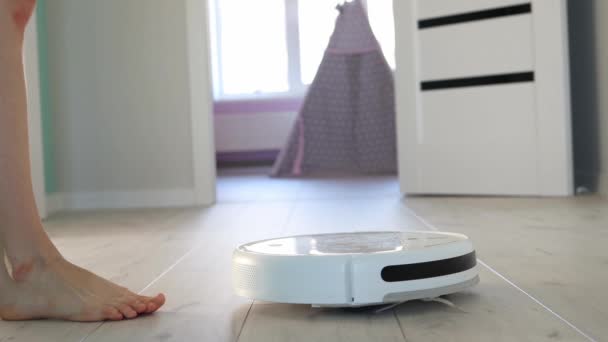 Close Young Girl Approaching Robot Vacuum Cleaner Pressing Start Button — Stok video