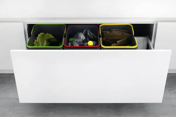 Colorful bins for sorting of plastic, paper garbage and organic waste at home. Modern kitchen with a system for sorting waste. Waste Separation Concept. Zero waste. Eco-friendly.