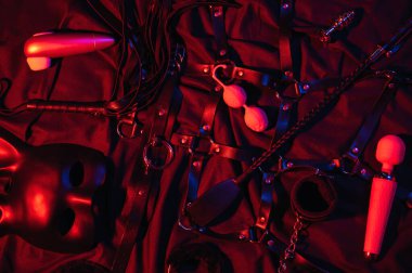 Vibrator, whip, handcuffs and mask for BDSM sex with submission and domination. A set of adult erotic sex toys