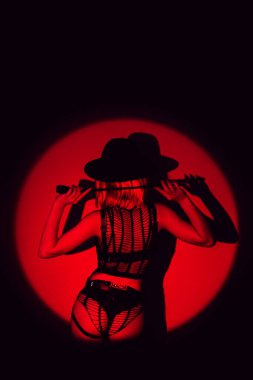 girl with a sexy ass in underwear and panties holds a leather flogger whip in hands for BDSM sex with submission and domination