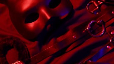 Vibrator, whip, handcuffs and mask for BDSM sex with submission and domination. A set of adult erotic sex toys
