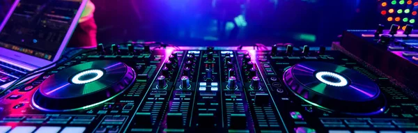 professional DJ music mixer at a party at an electronic music concert