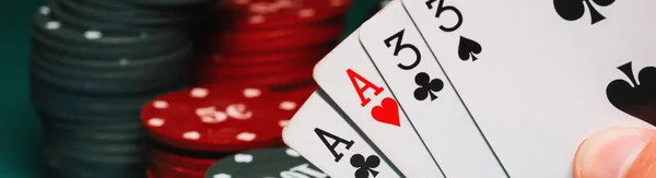 cards with two pairs in the hands of the player in a game of poker on the background of gaming chips in the casino