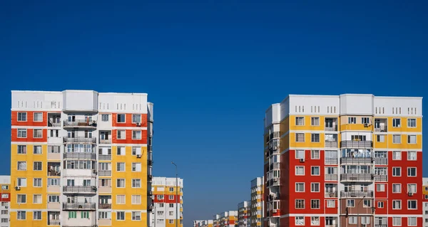 stock image residential new houses with windows and balconies on a blue sky background