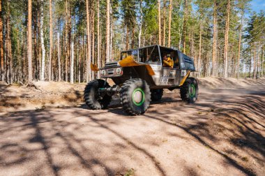 KARELİYA, RUSSIA REUKLİK - CIRCA HAZİRAN, 2022: Ladoga Gölü çevresindeki off-road turnuvası Ladoga Kupası 2022. 4x4 off-road cipi tozlu bir orman yolunda hızla gidiyor.