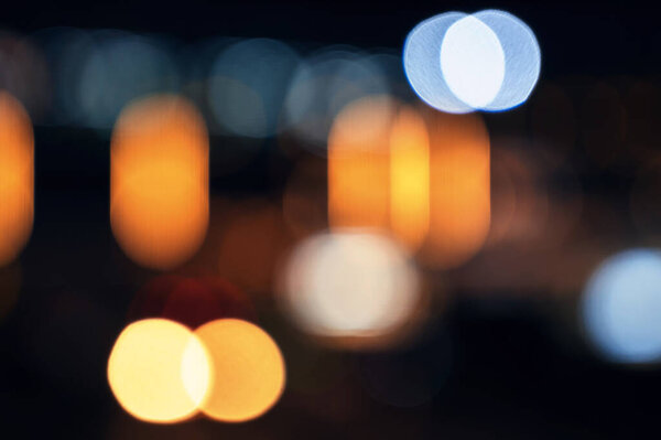 Blurred background with multicolored bokeh in night city on street