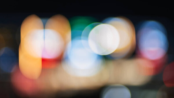 blurred bright background with multicolored bokeh with lights of night city