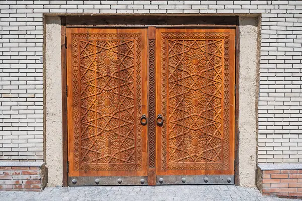 modern carved wooden gate with Islamic Uzbek carved pattern with stars ornament in oriental style in Uzbekistan in Tashkent