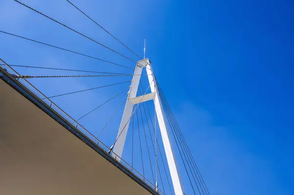 stock image construction of a modern cable-stayed bridge on background of blue sky in Anhor Park in Tashkent in Uzbekistan. New pedestrian suspension bridge