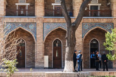 Students in the courtyard of ancient Islamic educational Kukeldash Madrasah. Tashkent, Uzbekistan - April 17, 2024 clipart