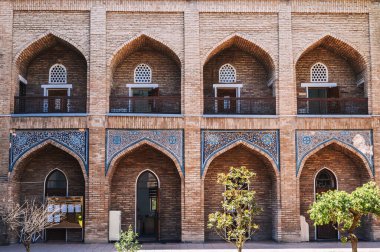 Cells of students in the courtyard of ancient educational Islamic madrasah Kukeldash in Tashkent in Uzbekistan clipart