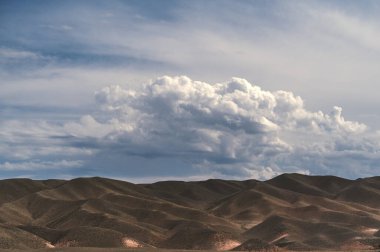 View of the desert in the Black Charyn Canyon in Kazakhstan in summer under a cloudy sky clipart