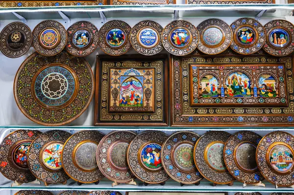 stock image Uzbek wooden gift plates and paintings with wood carvings hand-painted traditional patterns in the souvenir shop in Uzbekistan