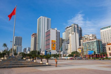 The central square of Nha Trang city with a view of skyscrapers and the flag of Vietnam. Nha Trang, Vietnam - July 31, 2024 clipart