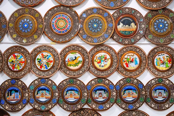 stock image handmade Uzbek wooden gift plates with wood carvings hand-painted asian patterns in the souvenir shop of Uzbekistan