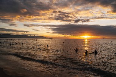 Sabahın köründe Nha Trang 'da Vietnamlı yüzücülerle deniz. Nha Trang, Vietnam - 19 Temmuz 2024