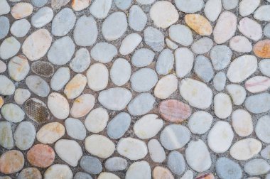 Çakıl taşı kaldırımının gri arkaplanı. Taş deseni