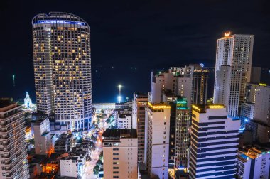 Asya 'daki tatil beldesi Nha Trang' ın panoramik gece görüntüsü. İHA 'dan gökdelenler geliyor. Nha Trang, Vietnam - 21 Temmuz 2024