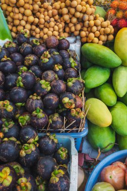 assortment of various tropical exotic Asian fruits on the counter in a store in Thailand at a street market clipart