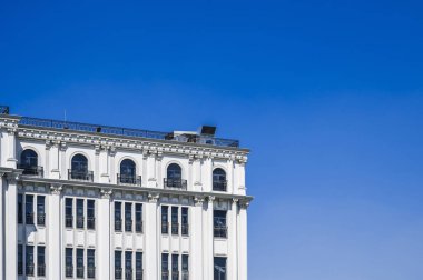 Mavi gökyüzünün arka planına karşı antik bir klasik binanın ön cephesi