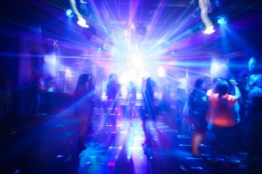 blurred silhouettes of dancing people at a nightclub party clipart