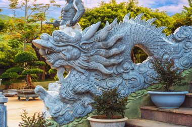 Stone Asian dragon statue on the stairs at Linh Ung Buddhist Pagoda in Da Nang in Vietnam in Asia clipart