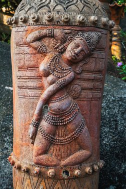 sculpture statue of a female deity on a Buddhist pagoda in Asia in Vietnam clipart