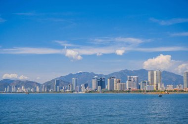 View from the sea of the Vietnamese city of Nha Trang on a sunny cloudy day. clipart