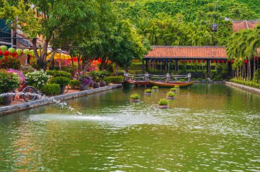 Da Nang, Vietnam yakınlarındaki Ba Na Hills 'de sazan havuzunun üzerinde geleneksel bir köprü..