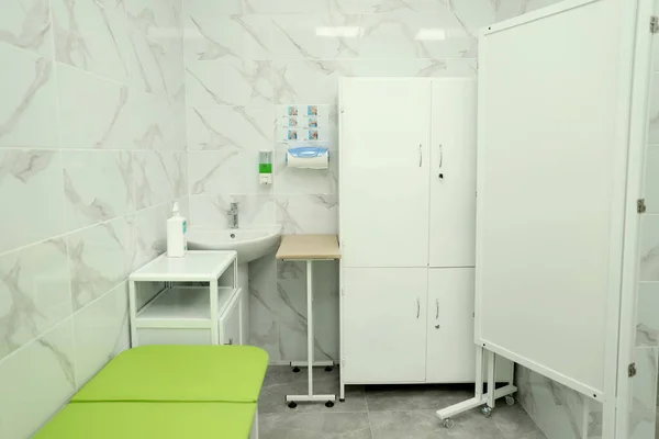 new medical office. Hospital restroom. Sanitary office. The room with the bed is clean and sterile. Medical equipment for nurses. High quality