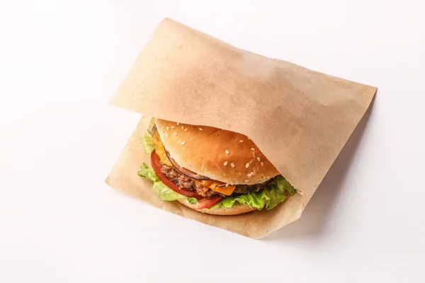 burger on a white background. Cut and fill. Meat and salad. Fast food minimalism. Junk food. Cholesterol. Peat board. Food stand Top view. Flatley.