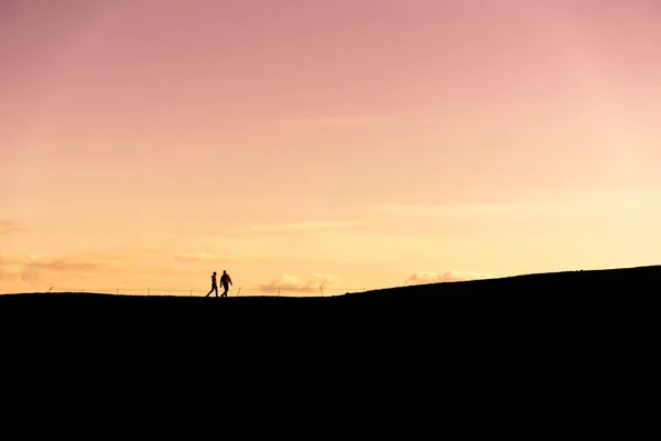 Unknown Couple Hiking Silhouette Sunset Stock Picture