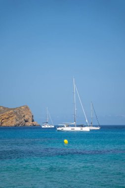 Turkuaz Akdeniz 'de demirli üç küçük yelkenli.