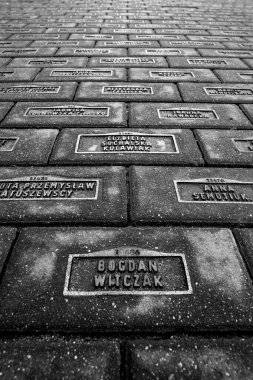 Polonya 'nın Lodz kentindeki Cobblestone Caddesi' nde Yahudi Soykırımı kurbanlarının isimleri kazınmış.