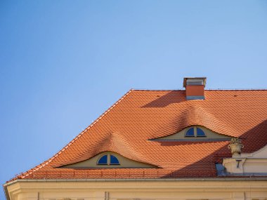 Ayırt edici kırmızı kiremit çatılı büyüleyici bir ev ve Wroclaw, Polonya 'daki mimari çekiciliğine ve karakterine kattığı sıcacık bir baca.