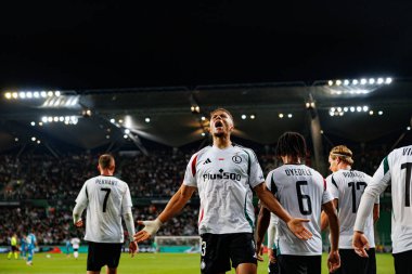 Steven Kapuadi  seen celebrating after scoring goal during UEFA Europa Conference League game between teams of  Legia Warszawa and Real Betis Balompie  at Stadion Miejski Legii Warszawa (Maciej Rogowski) clipart