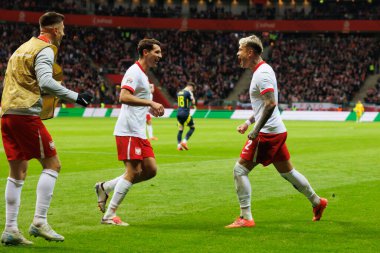 Jakub Moder ve Kamil Piatkowski, Polonya ve İskoçya milli takımları arasındaki UEFA Milletler Ligi maçında gol attıktan sonra PGE Narodowy 'da (Maciej Rogowski)