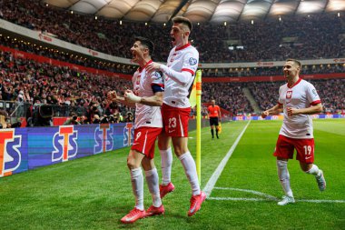Robert Lewandowski, Krzysztof Piatek ve Przemyslaw Frankowski, PGE Narodowy 'da (Maciej Rogowski) Polonya ve Litvanya milli takımları arasındaki Dünya Kupası 2026 Avrupa ön eleme maçında gol attıktan sonra kutlama yaparken görüldü.)