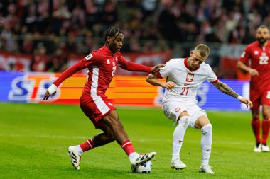Paul Mbong ve Mateusz Bogusz, 2026 Dünya Kupası eleme maçında Polonya ve Malta milli takımları arasında PGE Narodowy (Maciej Rogowski)