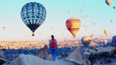 Kadın gezgin kış zamanı sıcak hava balonları festivali ile Kapadokya 'ya yürür. Yüksek kalite 4k görüntü