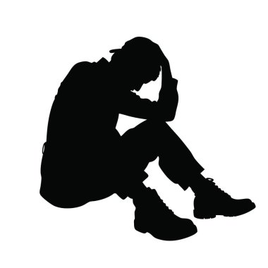 Kafası ellerinin arasında yerde oturan bir adam.