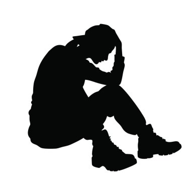 Yerde oturan bir kişinin silueti.