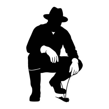 Fötr şapka takan bir adamın siyah silueti çömelmiş olarak tasvir edilir. O, uzun kollu bir gömlek ve pantolon giyiyor, ellerinde eldivenlerle. Bir eli dizinin üzerinde, diğer eli de yere yakın. Bir araç, muhtemelen bir kazı ya da p