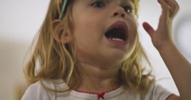 Close-up of beautiful little girl playing with her sunglasses. High quality 4k footage