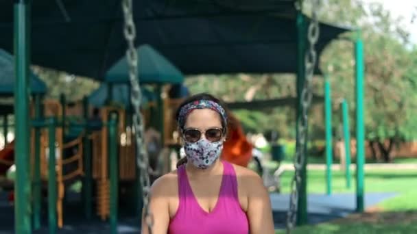 Mother Wearing Face Mask Pushing Little Girl Swing Playground High — Stockvideo