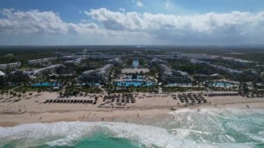 Beyaz kum plajı ve mavi okyanus kıyısındaki havuzları ve restoranları olan eğlence alanı güzel bir manzara. Hard Rock Hotel - Punta Cana Dominik Cumhuriyeti, Şubat 2022.