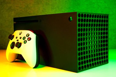 Xbox oyun konsolu ile neon arkaplan üzerinde bir oyun denetleyici