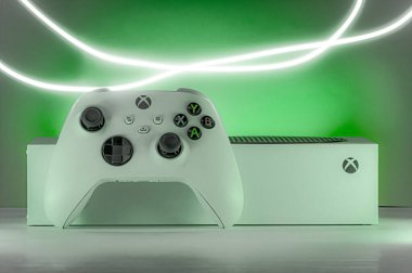 video game console and gamepad with green background